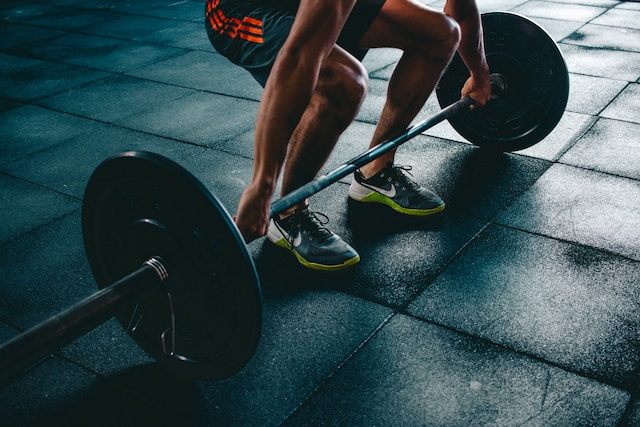 Image shows person lifting heavy weights