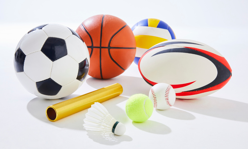 Image shows a football, basketball, netball, rugby ball, relay baton, shuttlecock, tennis ball and softball.