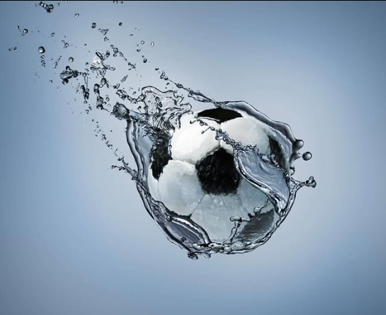 Image shows a football falling with force through water