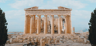 Image shows a photograph of the Acropolis in Athens, Greece