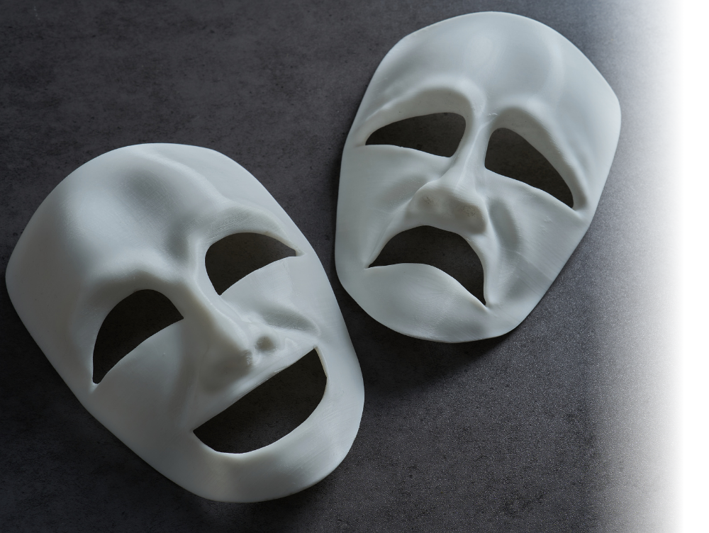 Image shows 2 plain white masks, one with a happy smile, the other with an unhappy downturned mouth