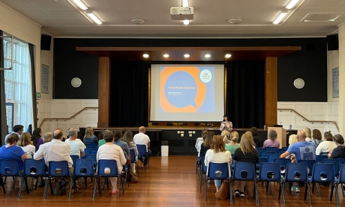 Image shows parents sitting in the College's Main Hall for a talk on adolescent mental health given by Julie Castleman from the  Charlie Waller Trust